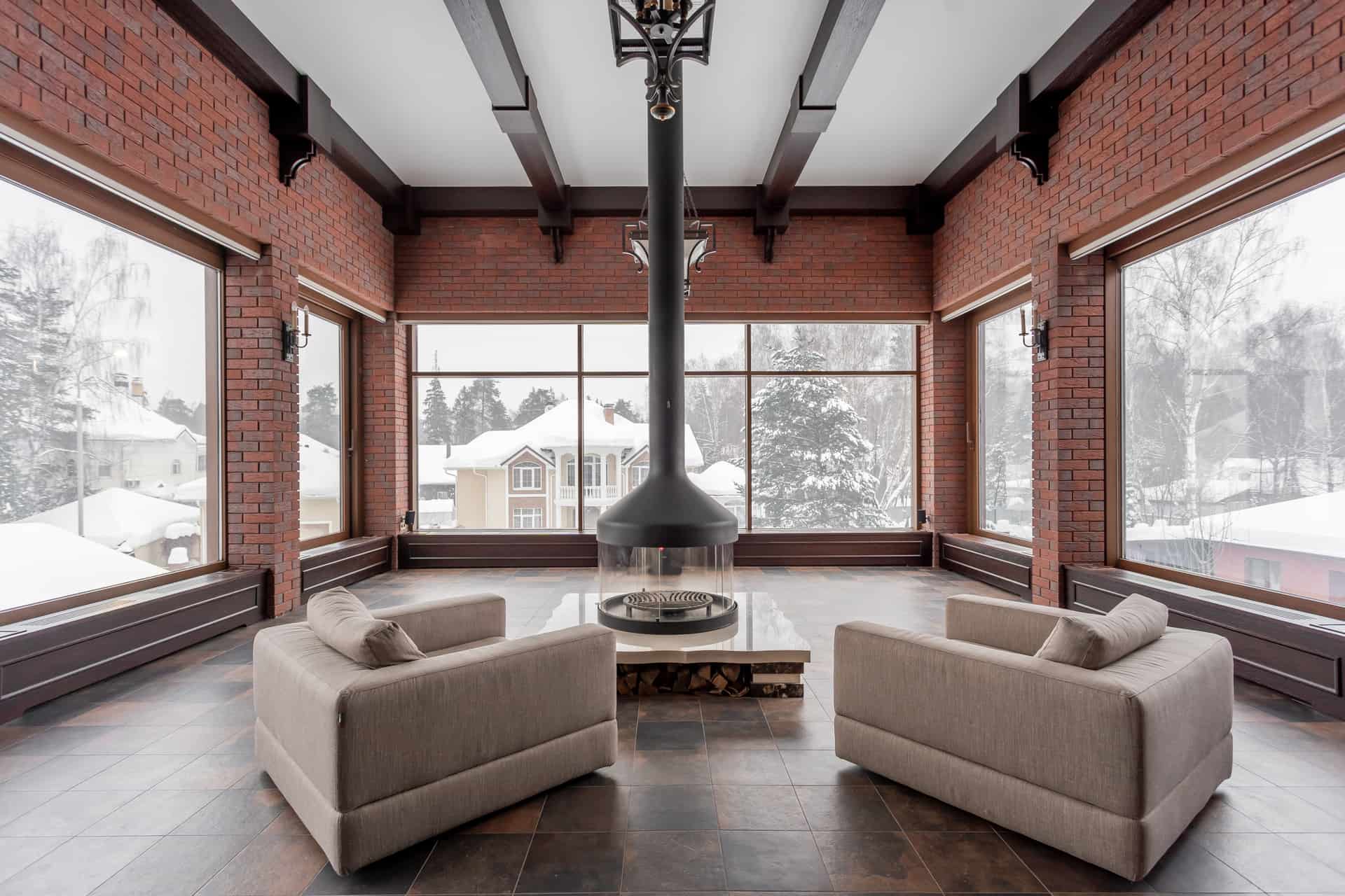 A spacious living room with high windows in winter